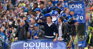 Members of the Chelsea football squad parade through the streets of west London on May 16, 2010 as they celebrate winning the the Barclays Premiership Trophy and FA Cup during their victory parade