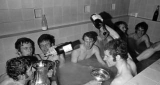 Chelsea striker Peter Osgood pours champagne over his head as goalkeeper Peter Bonetti (front left) uses the trophy lid to catch the drink in the dressing room bath after the Chelsea v Leeds United FA Cup Final Replay held at Old Trafford, Manchester on the 29th April 1970. The other players, back left to right are Tommy Baldwin, John Hollins, Peter Houseman, Ron Harris, Marvin Hinton and Ian Hutchinson. Chelsea won the match 2-1.  