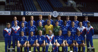 Chelsea Football Club, 1st team squad, at Stamford Bridge, August 1990. Back row (left-right): Damian Matthew, Graham Stuart, Gareth Hall, Erland Johnsen, Kerry Dixon, Andy Townsend, Steve Clarke, Graeme Le Saux, Kevin McAllister. Middle row: Frank Sibley (reserve team coach), Bob Ward (physiotherapist), Jason Cundy, David Lee, Roger Freestone, Dave Beasant, Kevin Hitchcock, Ken Monkou, Alan Dickens, Gwyn Williams (assistant manager), Dave Collyer (youth coach). Front row: John Bumstead, Dennis Wise, Peter Nicholas, Bobby Campbell (manager), Gordon Durie, Tony Dorigo, Kevin Wilson. 