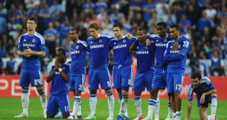 MUNICH, GERMANY - MAY 19:  Didier Drogba prays as his team mates look on in the penalty shoot out during UEFA Champions League Final between FC Bayern Munich and Chelsea at the Fussball Arena Munich on May 19, 2012 in Munich, Germany.  