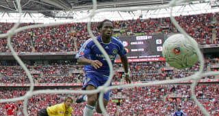 Friday Didier Drogba puts the ball past Manchester United's goalkeeper Edwin Van Der Sar (L) to win 1-0 at Wembley Stadium in 19 May 2007, during the FA Cup Final football match.