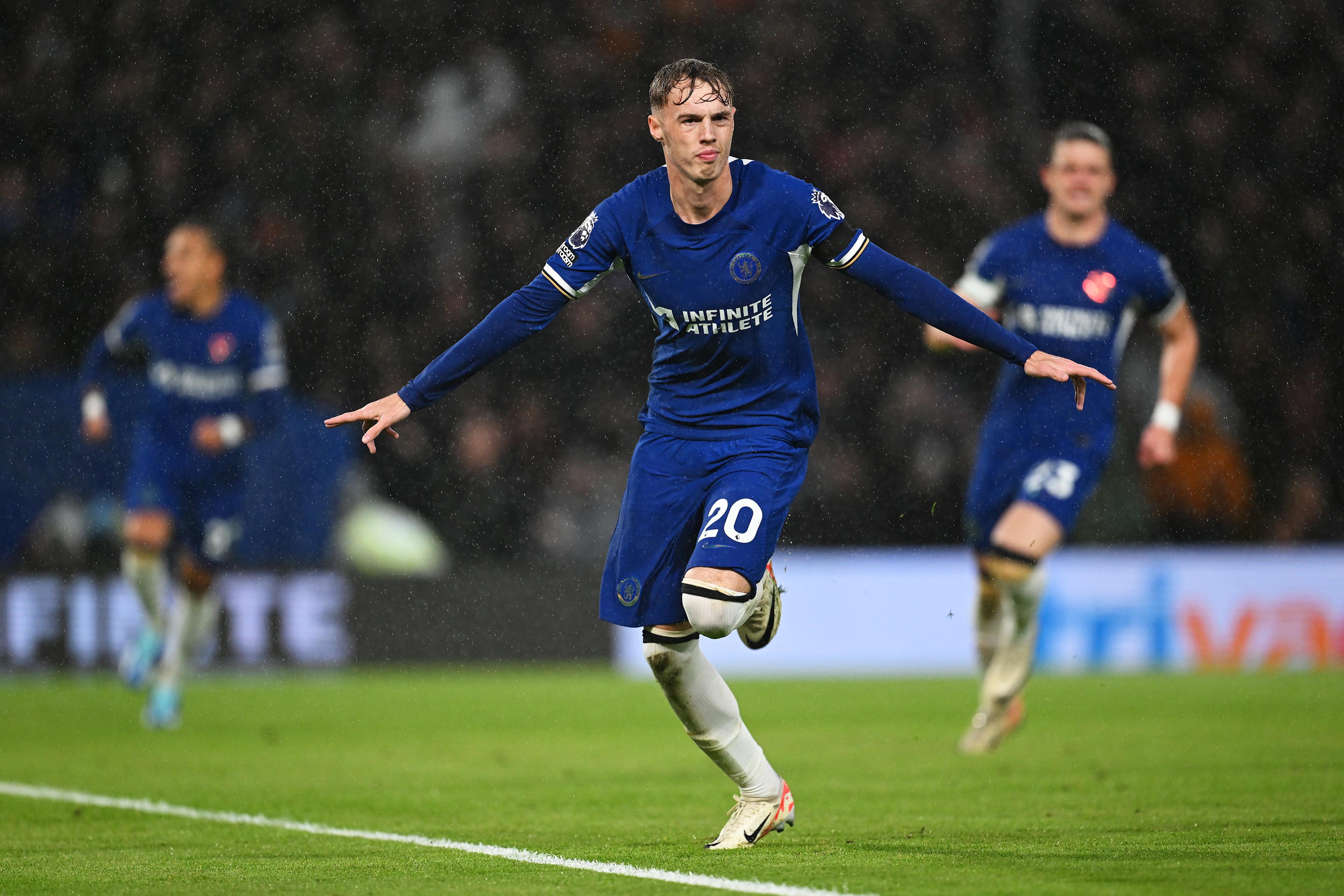Cole Palmer celebrates a Chelsea goal in the rain at Stamford Bridge