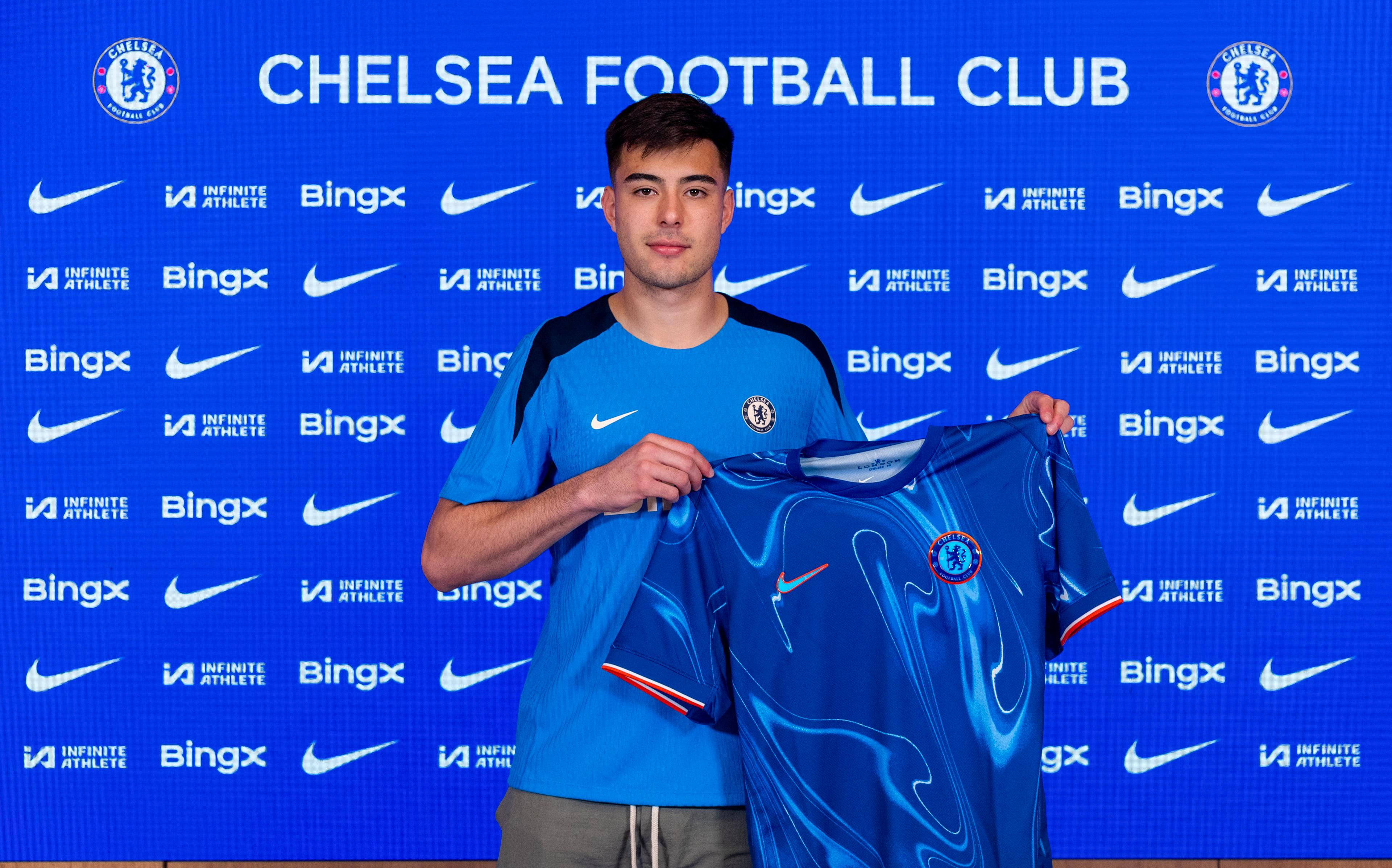 Aarón Anselmino holds a Chelsea shirt after completing his transfer in August 2024