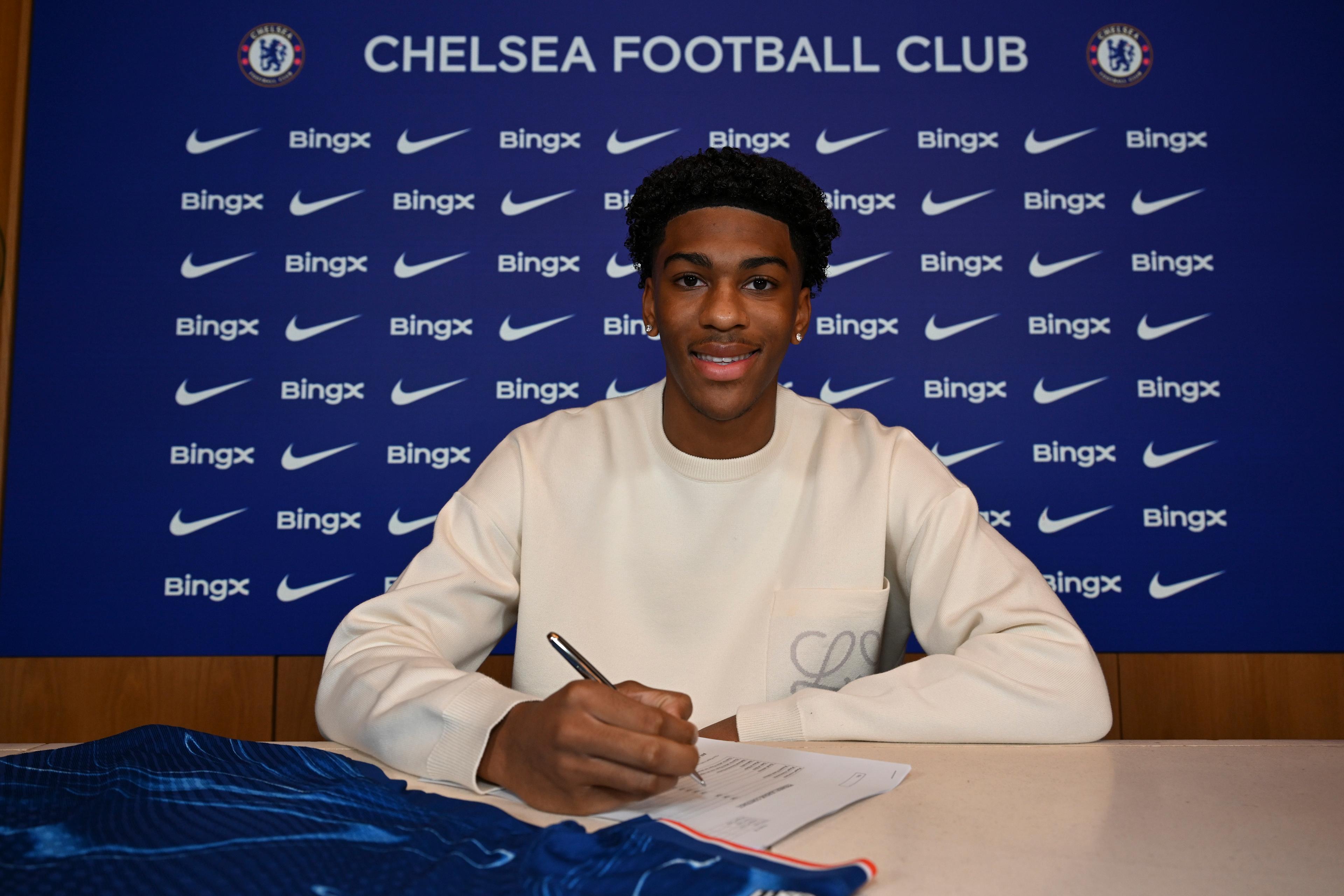Josh Acheampong poses at Cobham after signing a new Chelsea contract in December 2024