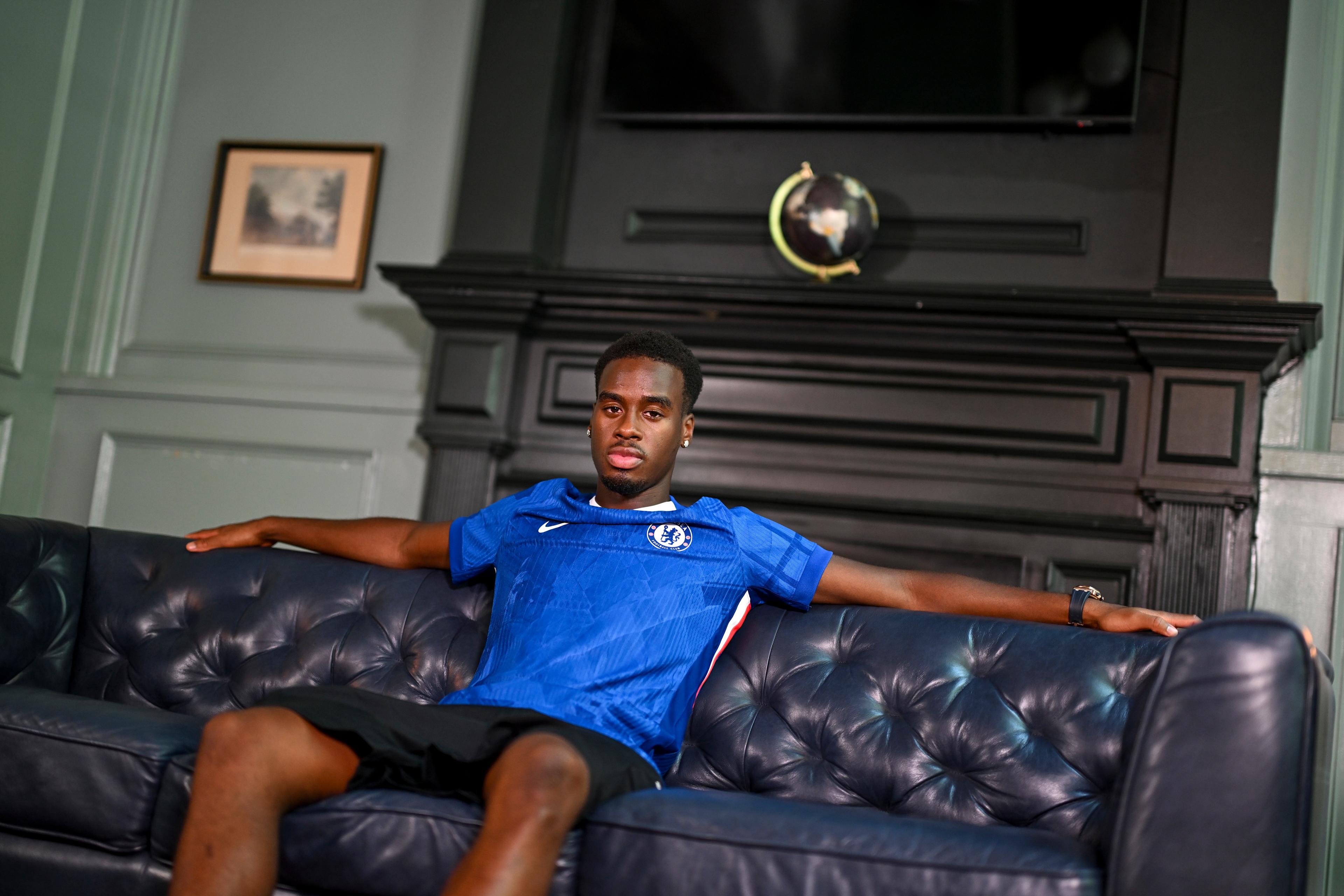 Jamie Gittens poses in a Chelsea shirt after signing for the club in July 2025
