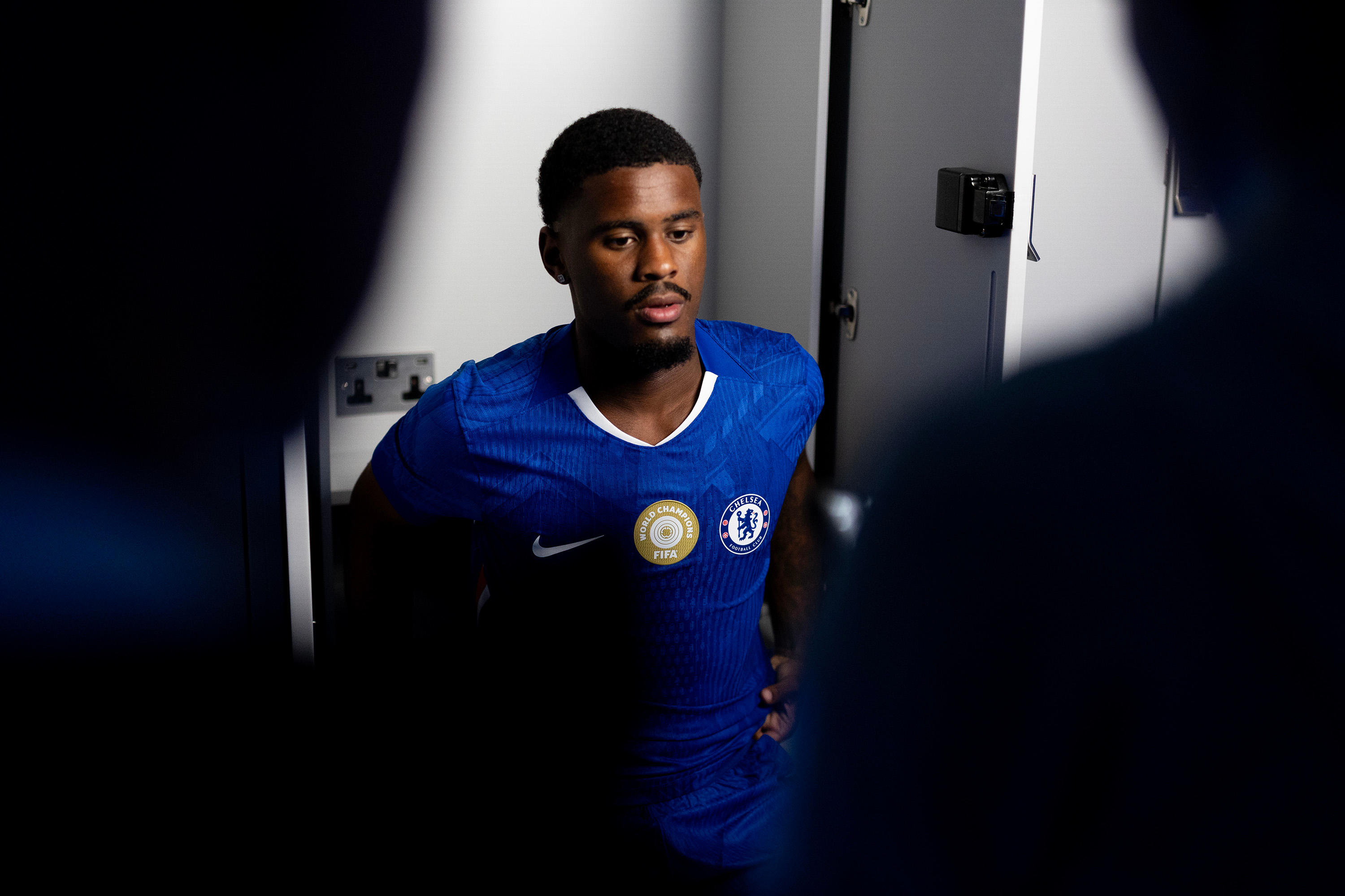 Jorrel Hato poses at Stamford Bridge after signing for Chelsea