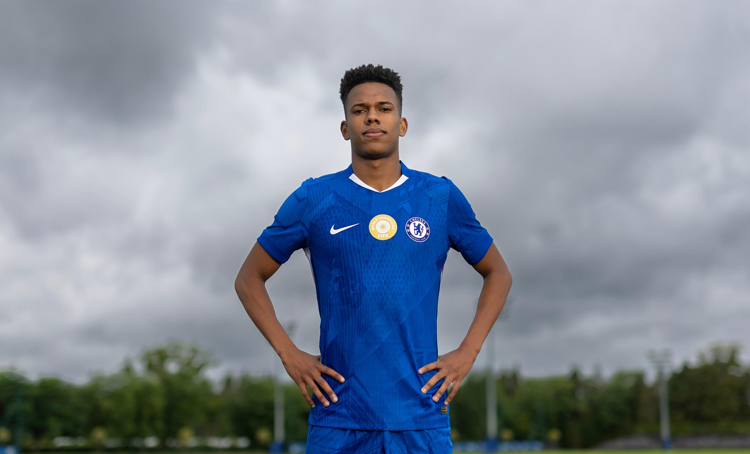 Estêvão holds a Chelsea shirt after arriving at the club in August 2025