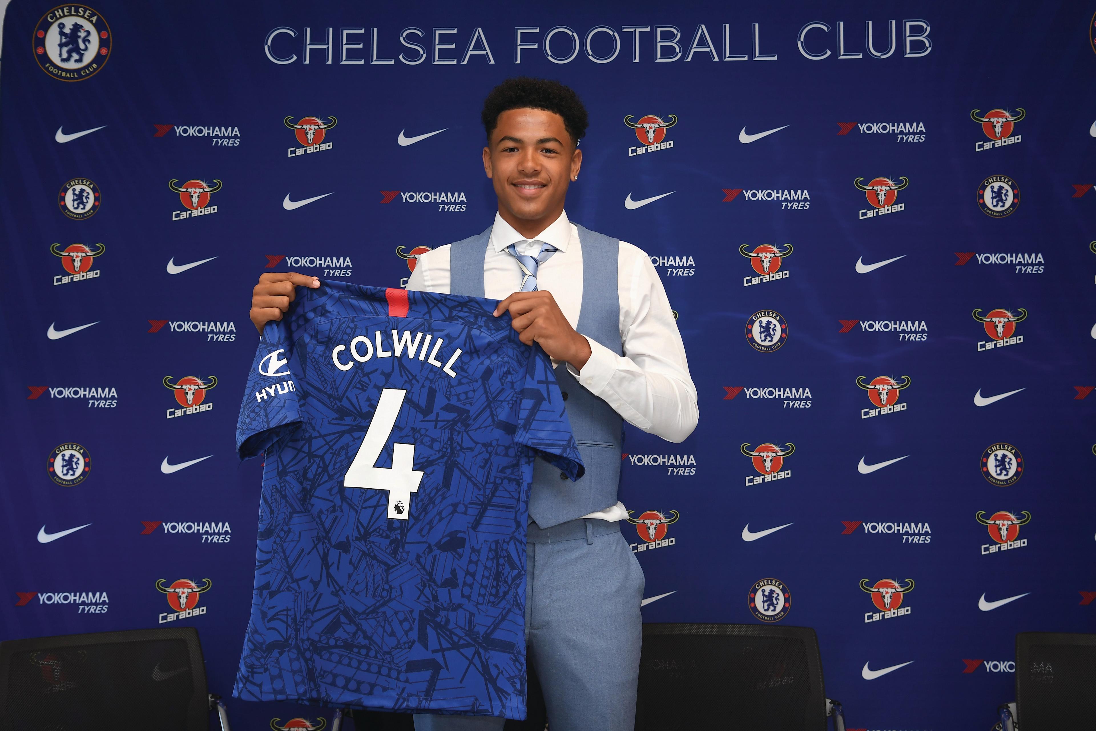 Levi Colwill signs his Chelsea scholarship paperwork as a teenager