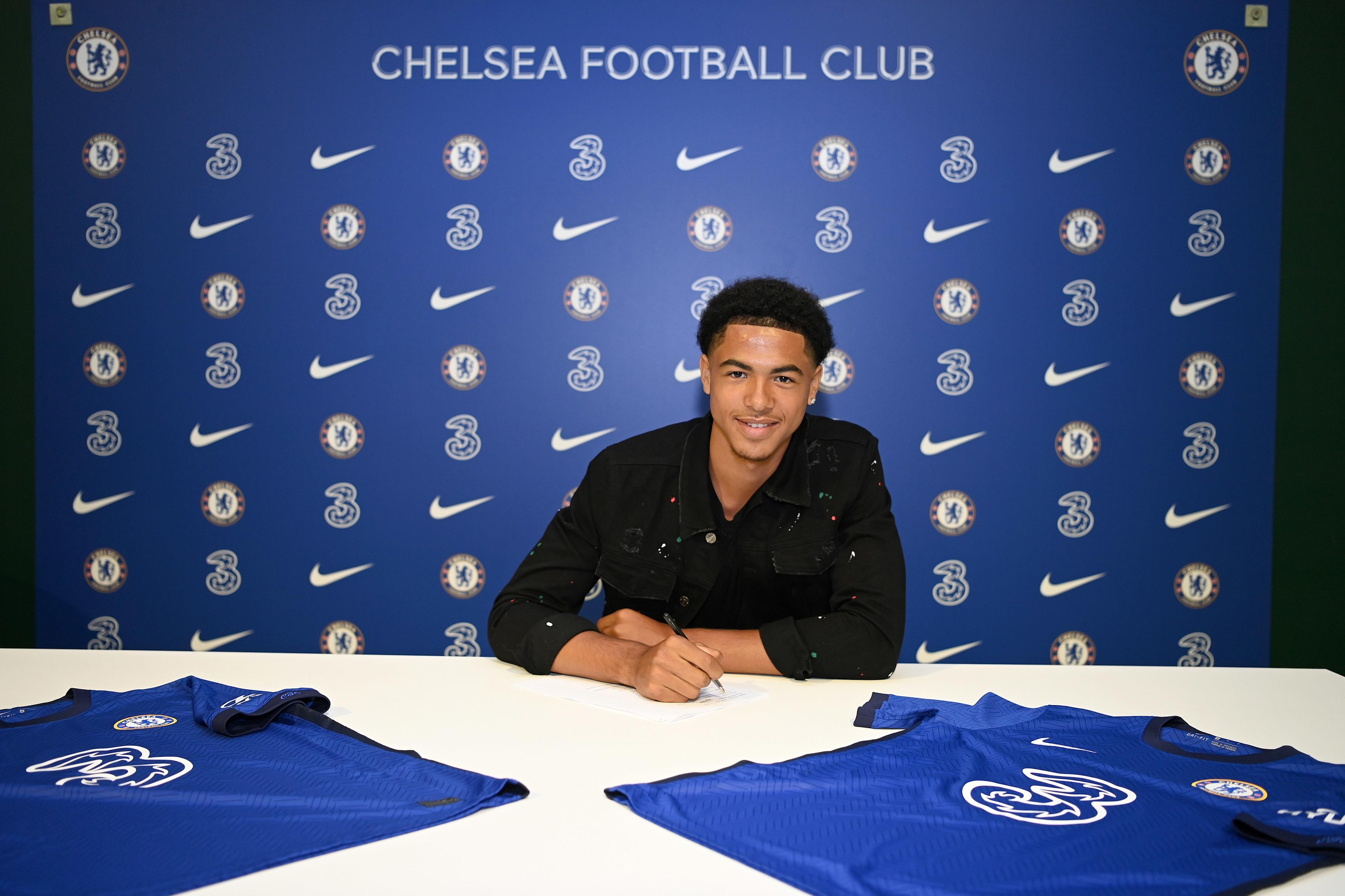 Levi Colwill poses after signing his first professional Chelsea contract