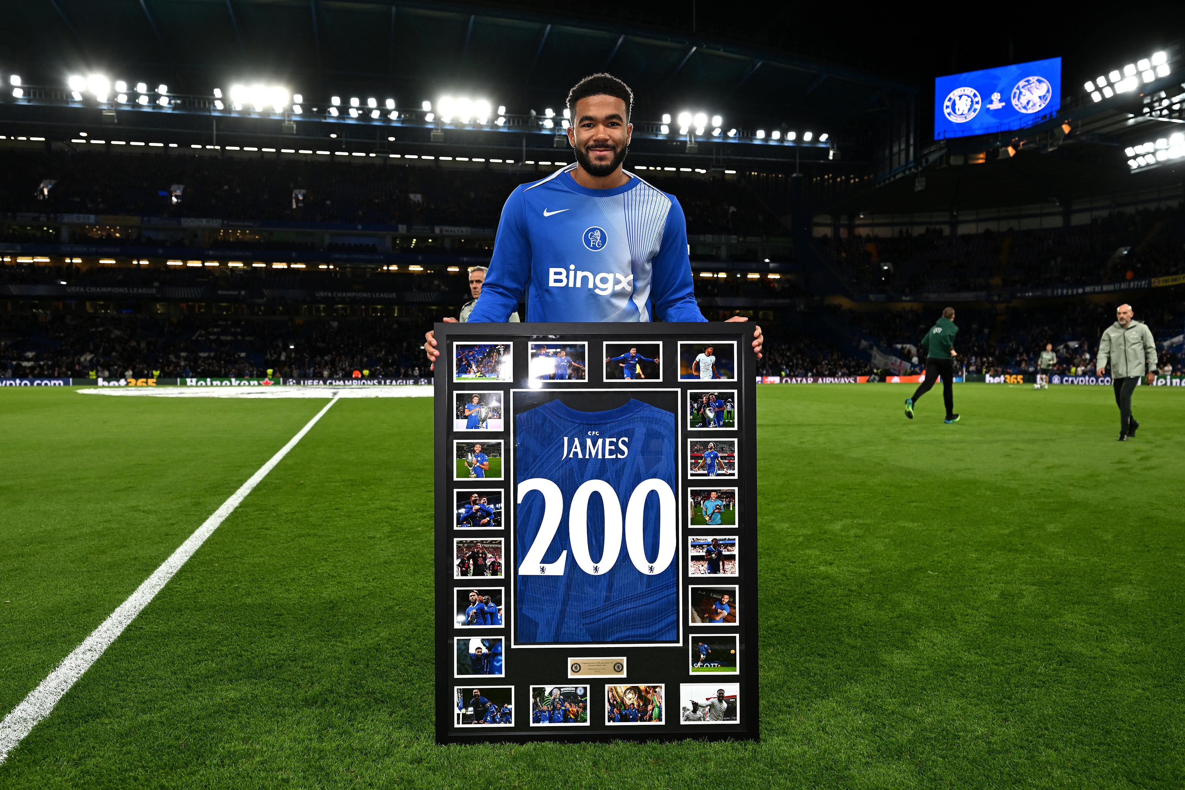 Reece James holds a framed Chelsea shirt marking his 200th appearance