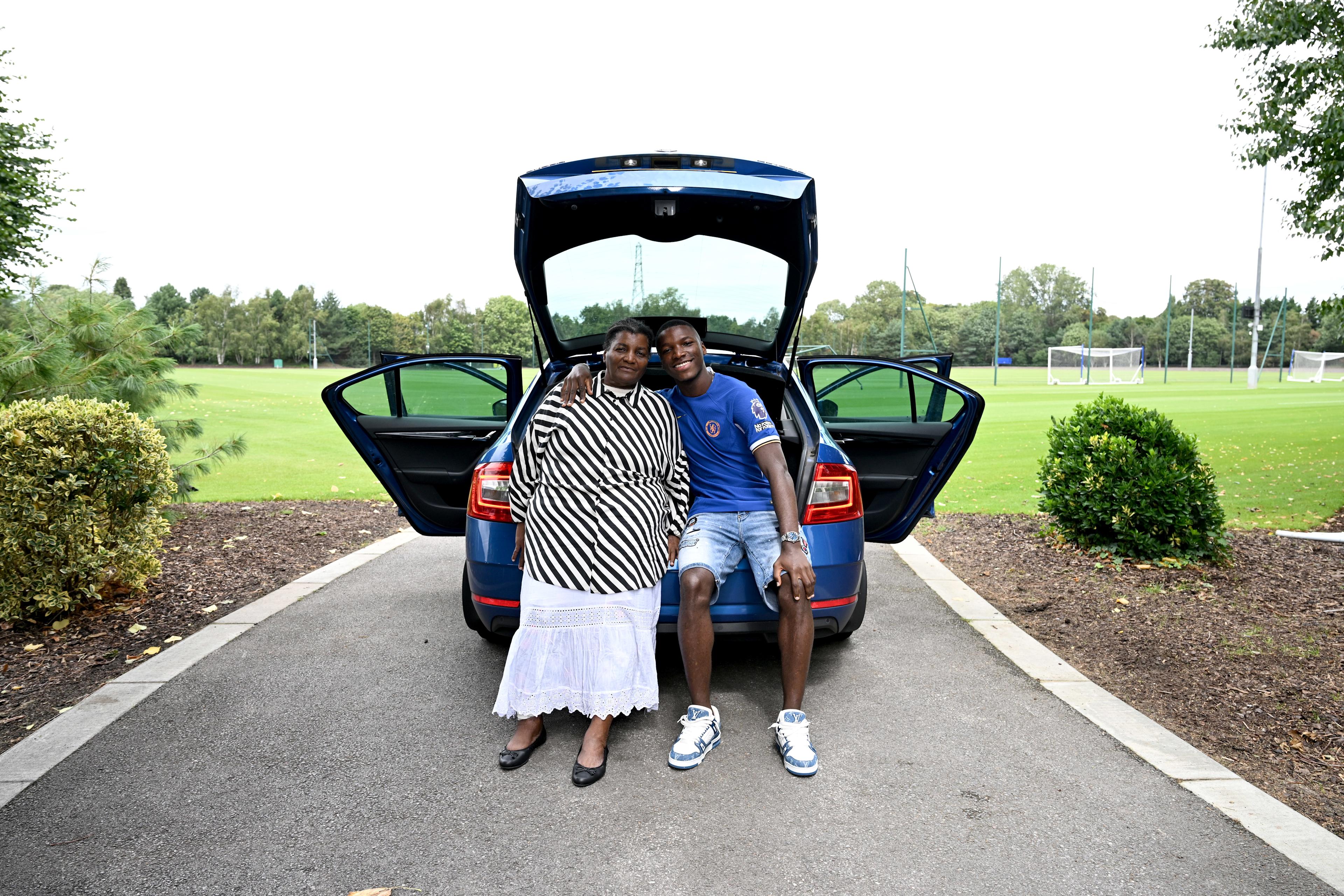 Moisés Caicedo recreates a childhood photograph with his mother at Cobham in August 2023