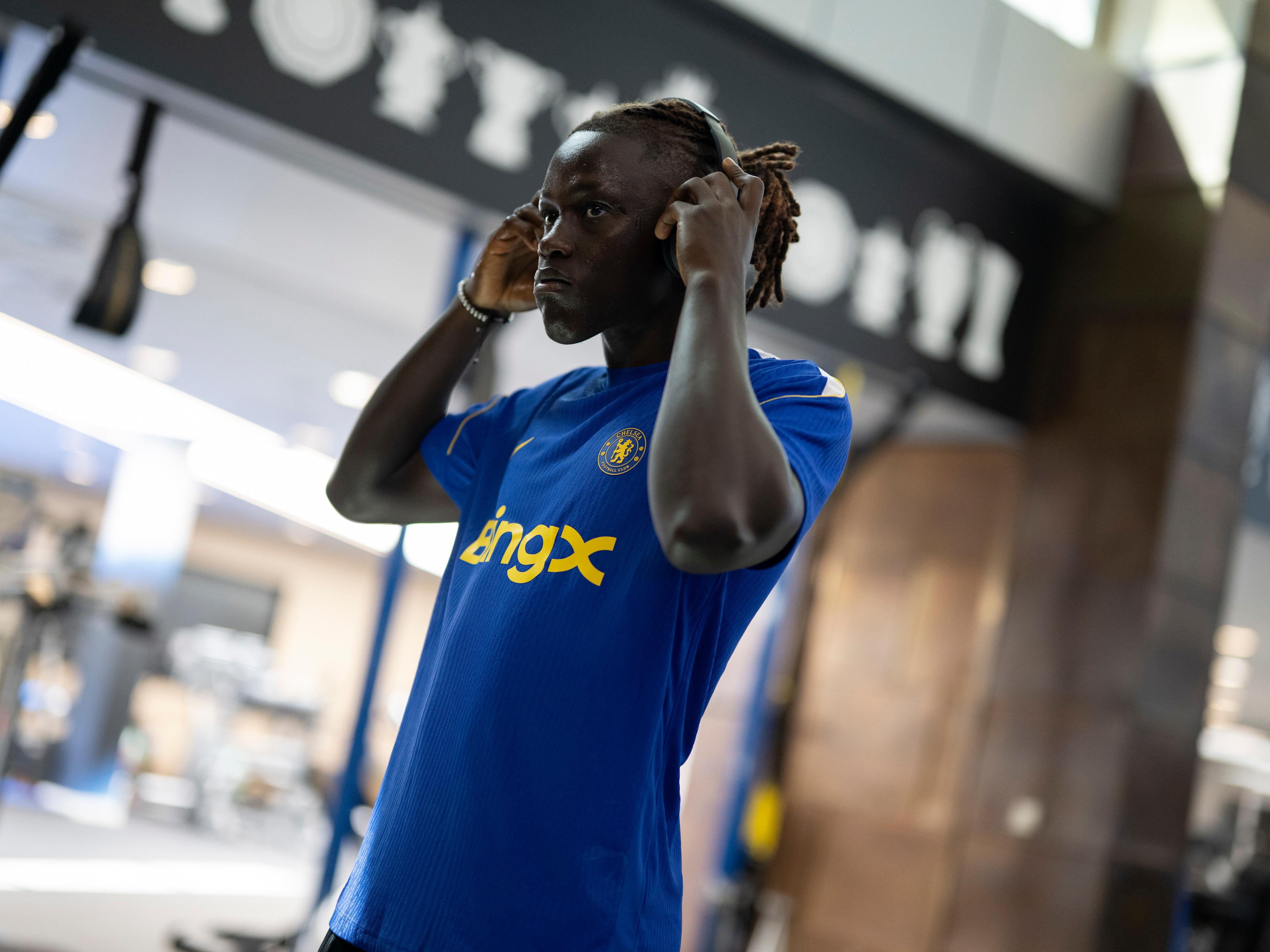 Geovany Quenda puts on headphones during his first day at Cobham