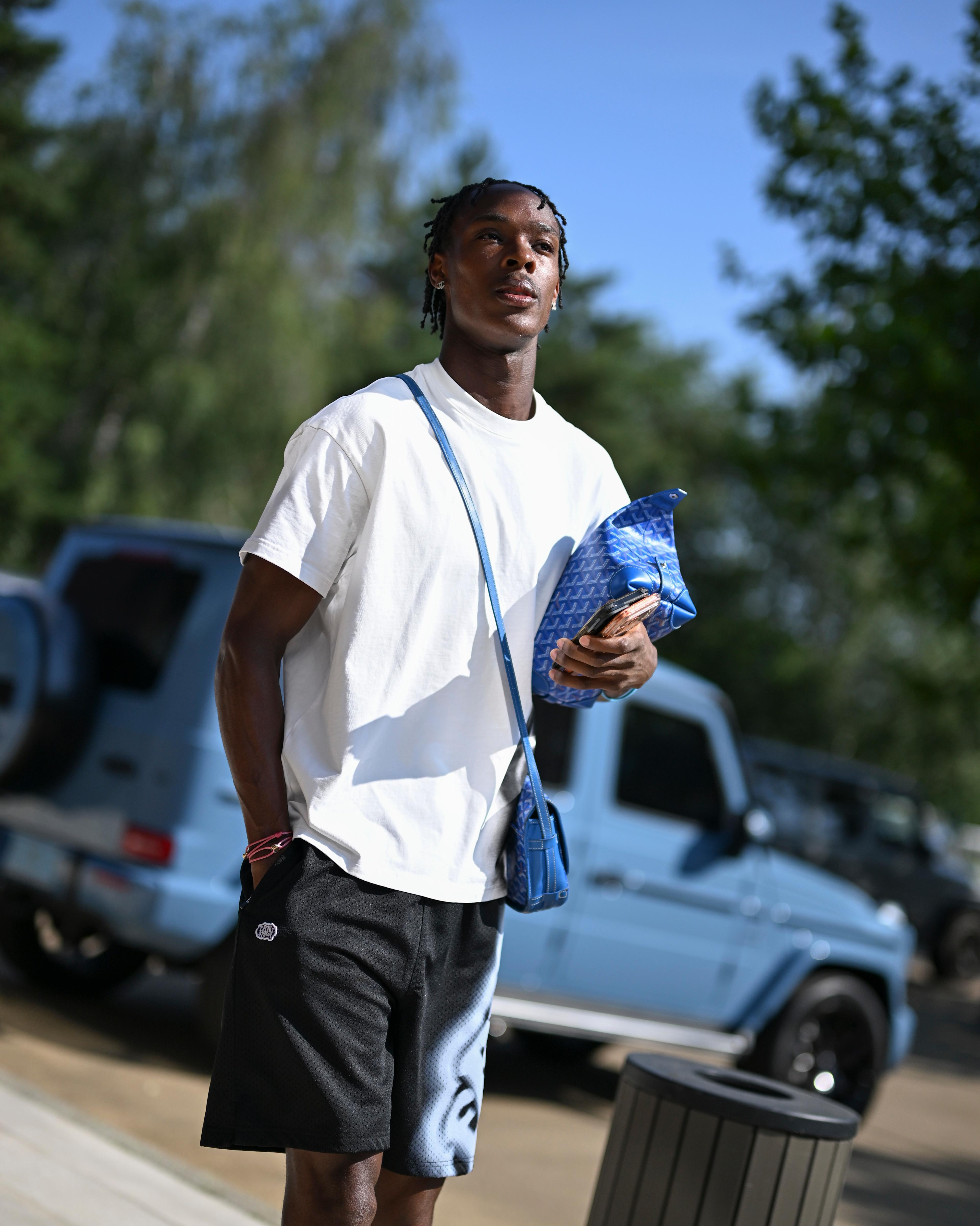 Emanuel Emegha arrives at Cobham for Chelsea pre-season carrying a blue bag