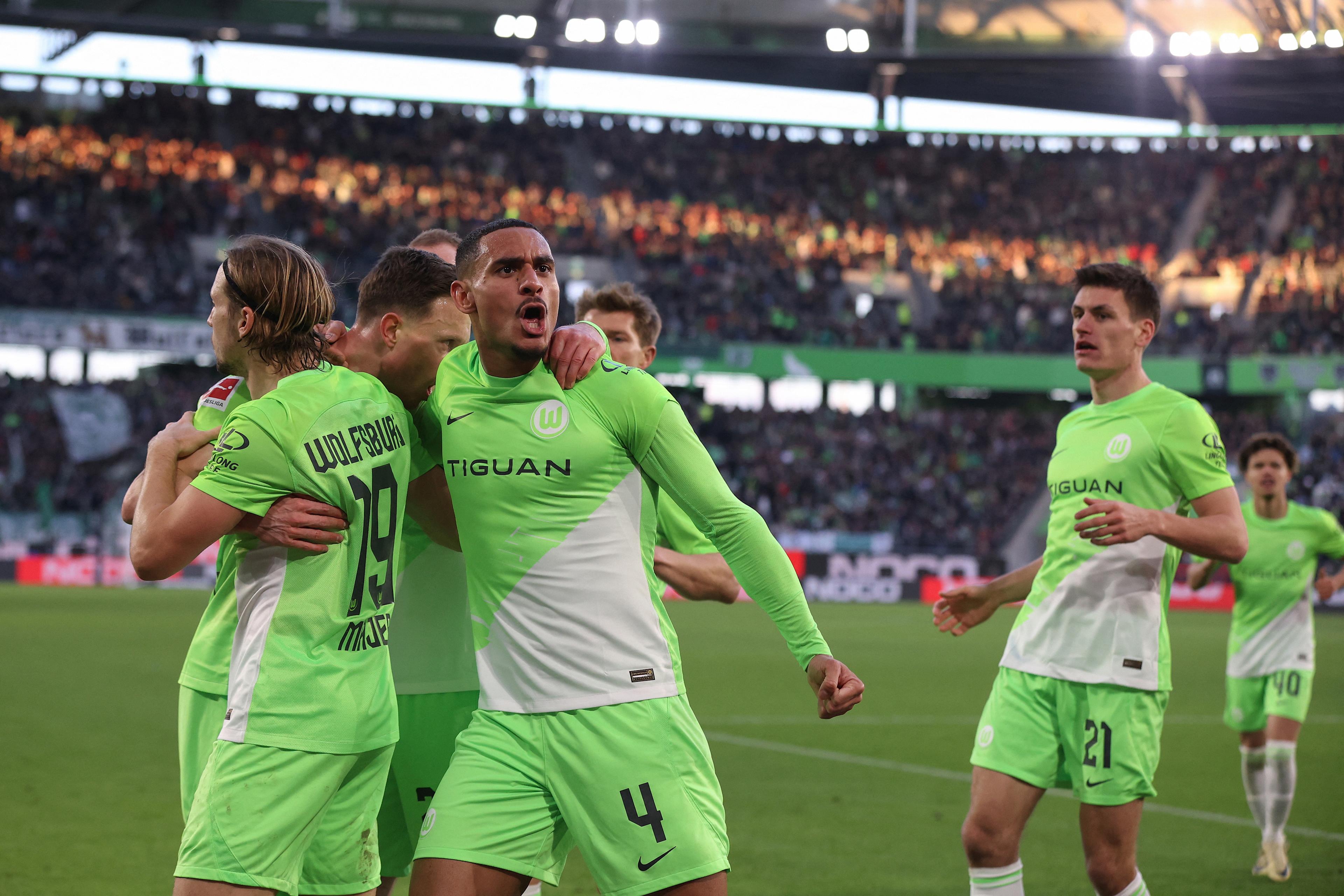 Maxence Lacroix celebrates scoring for Wolfsburg