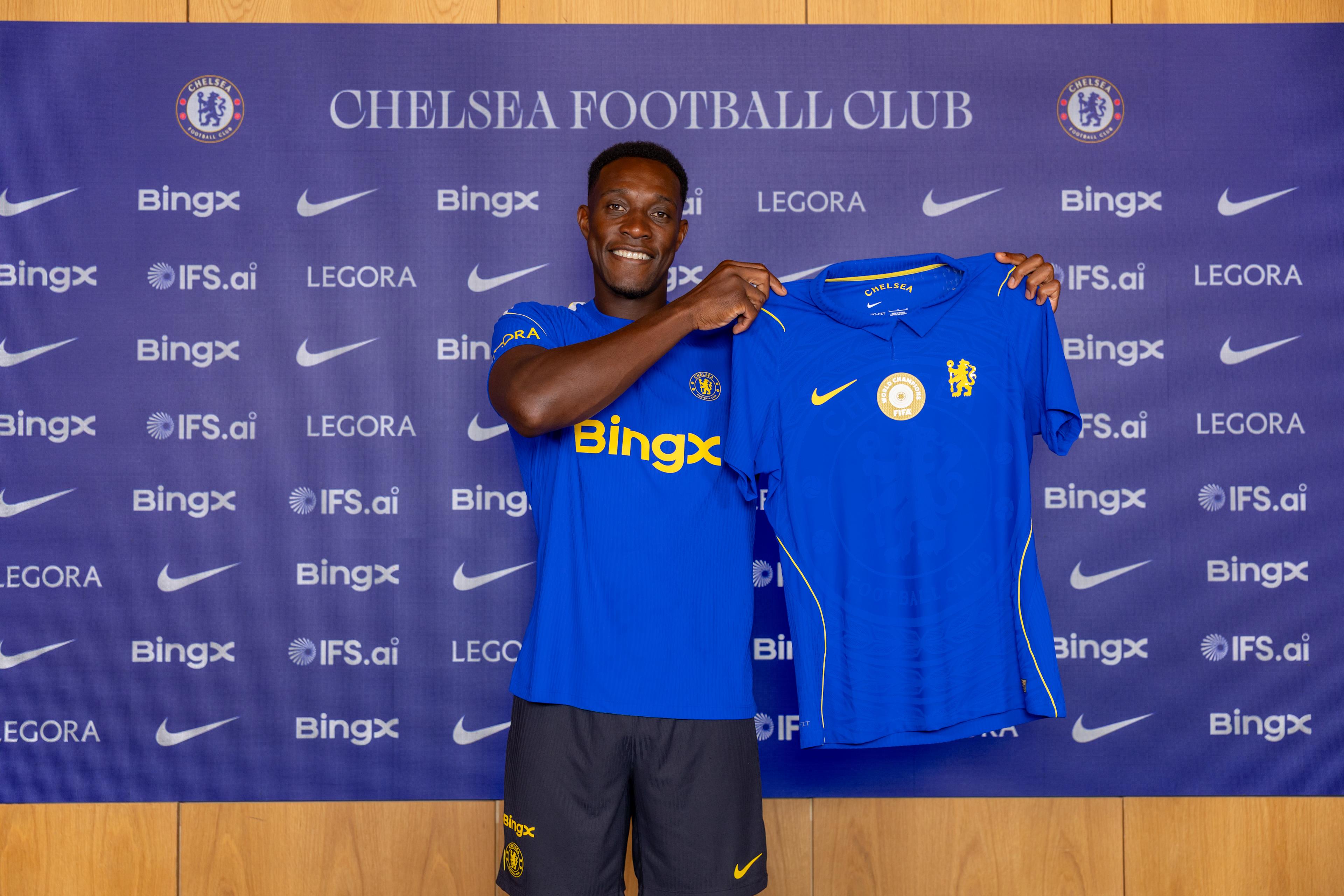 Danny Welbeck holds a Chelsea shirt after completing his move in July 2026