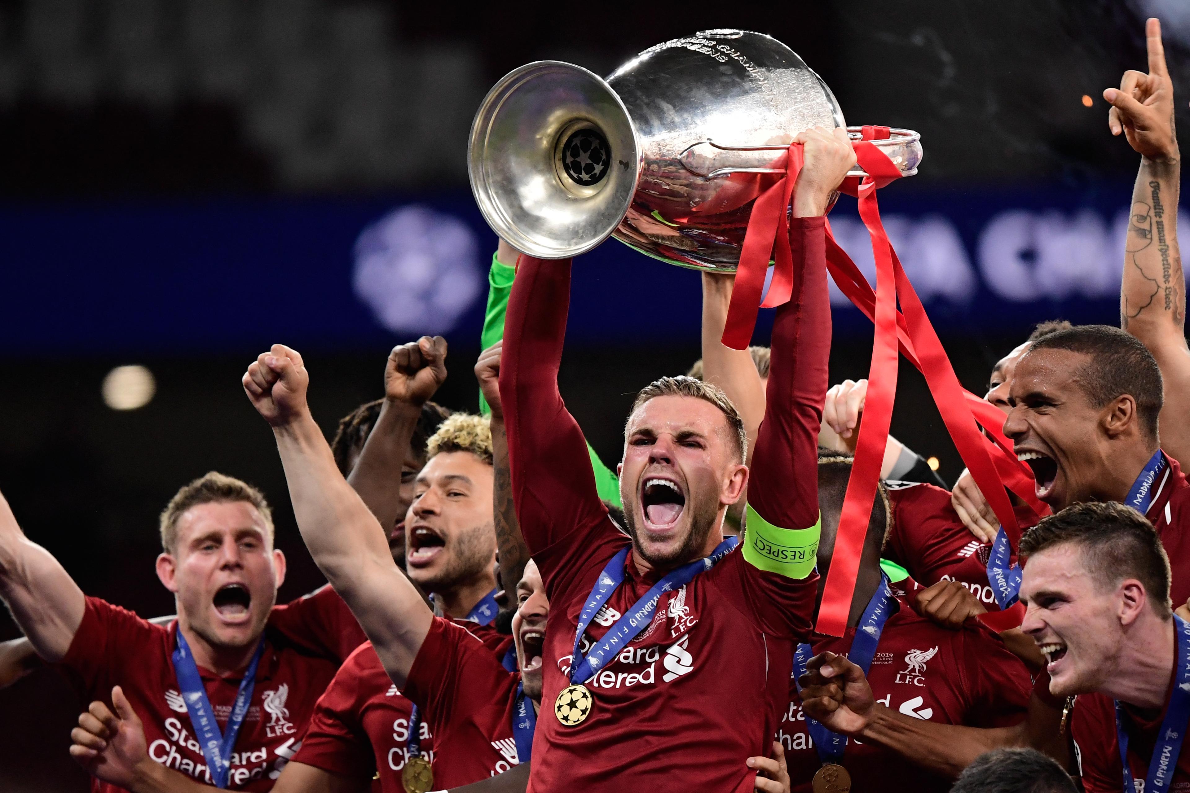 Jordan Henderson lifts the Champions League trophy as Liverpool captain in 2019