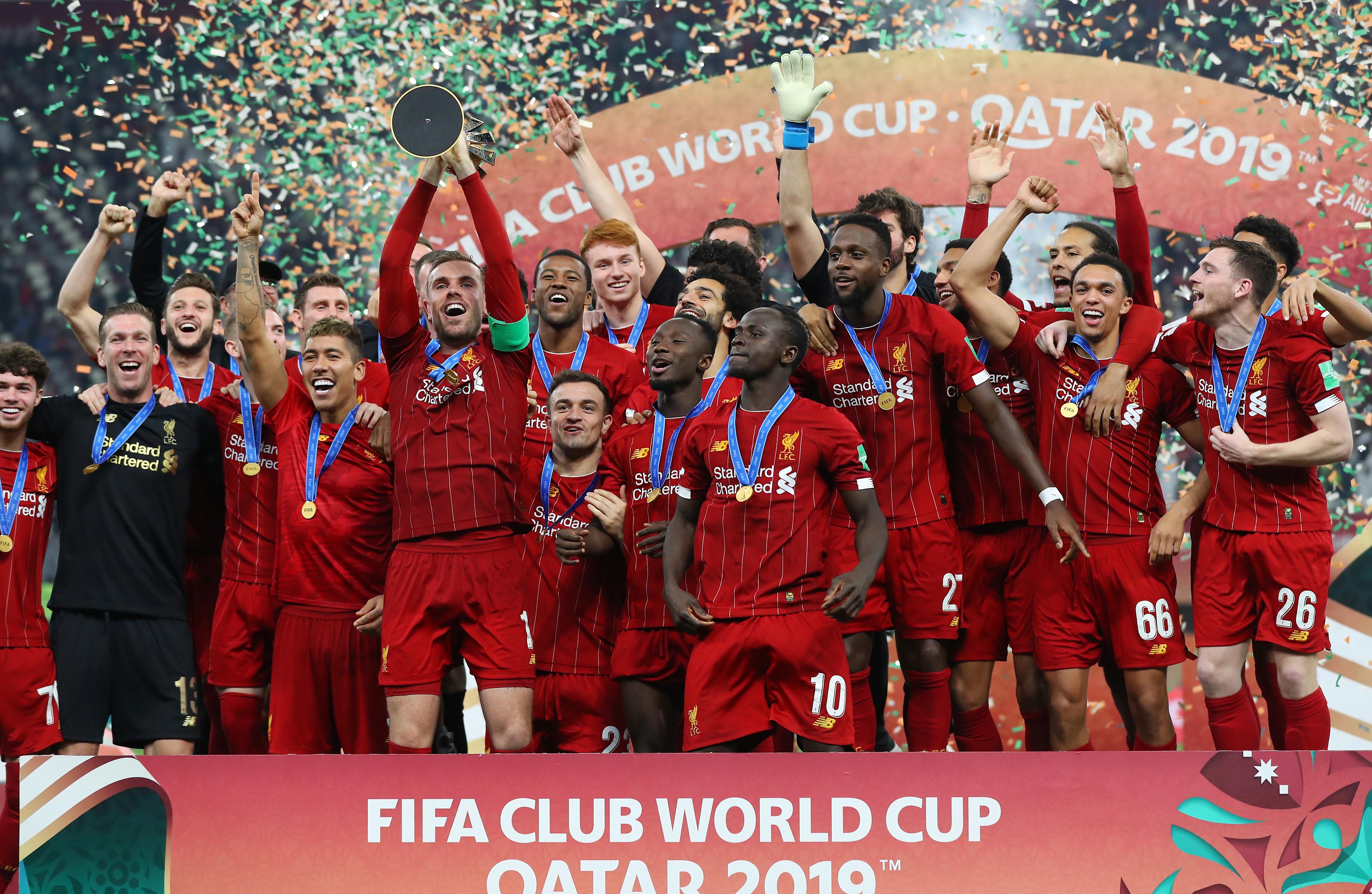 Jordan Henderson holds the Club World Cup trophy after Liverpool's 2019 final victory