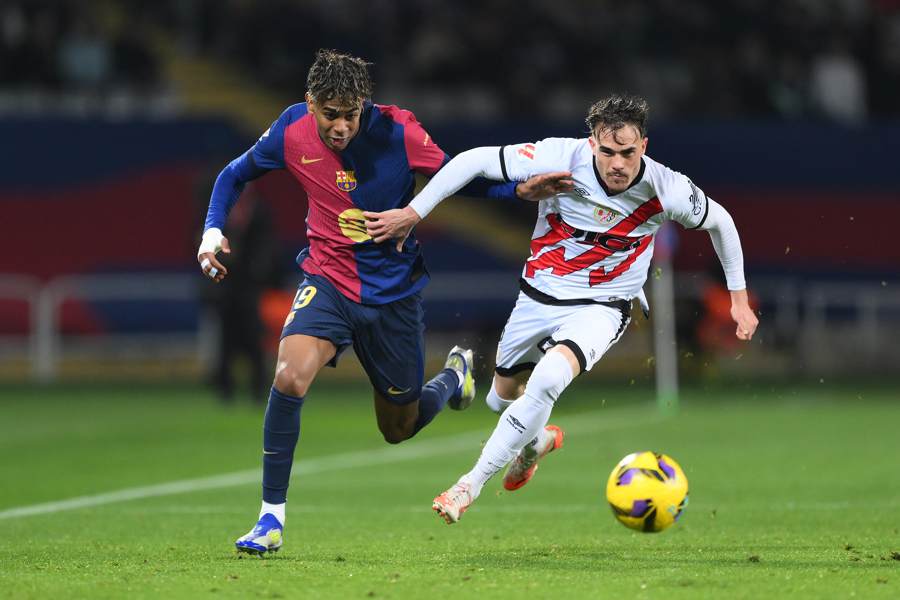 Pep Chavarría challenges Barcelona winger Lamine Yamal for the ball