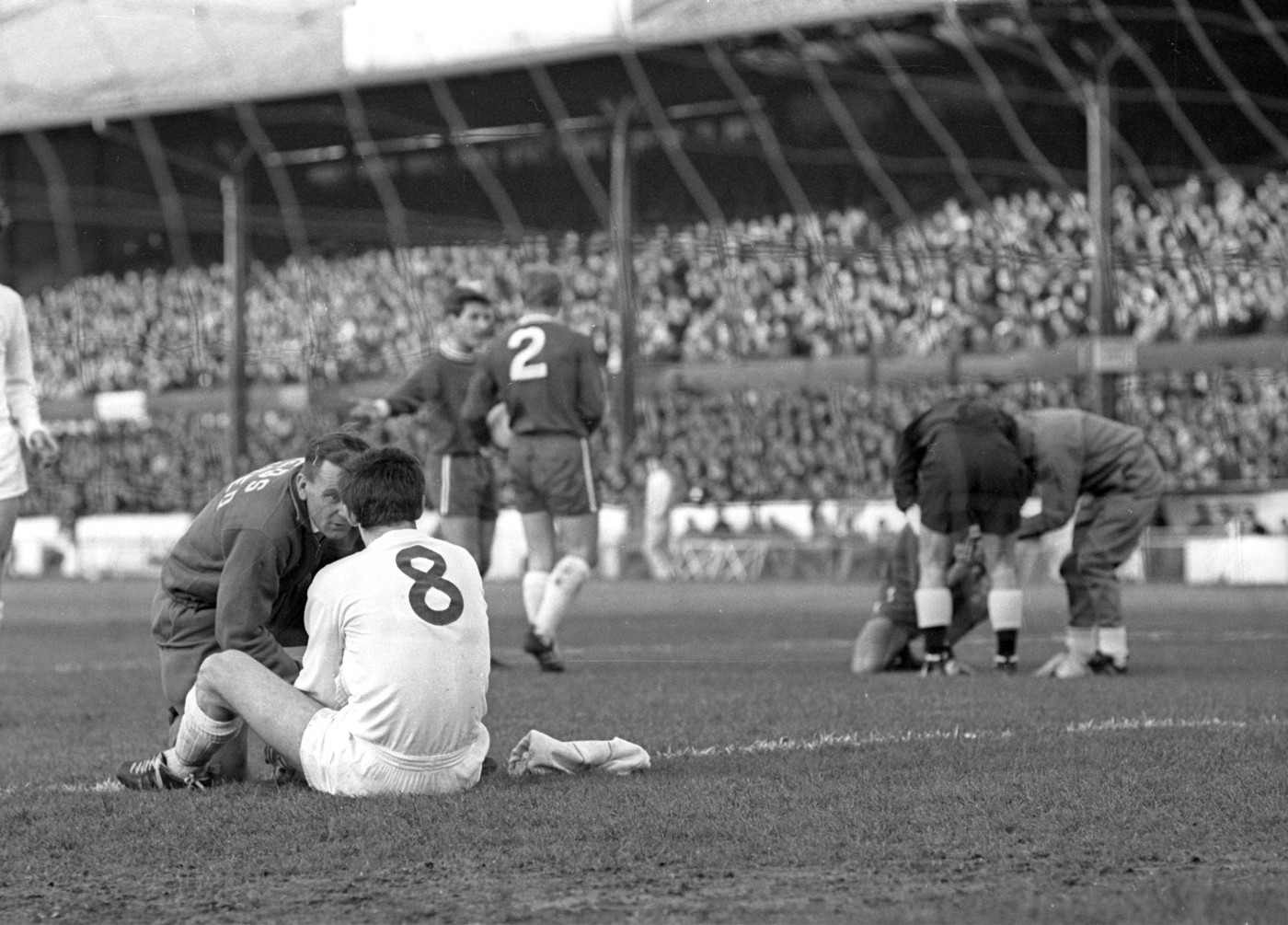 Players from both teams receive treatment in 1965