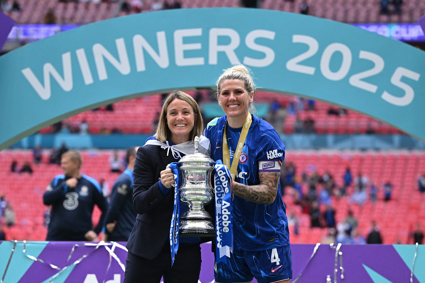 Millie Bright lifts the third trophy of the 2024/25 season with boss Sonia Bompastor