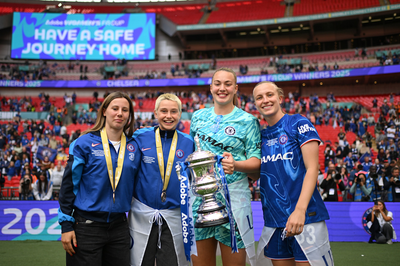 Vera Jones poses with the Women's FA Cup trophy alongside Lola Brown, Katie Cox and Aggie Beever-Jones