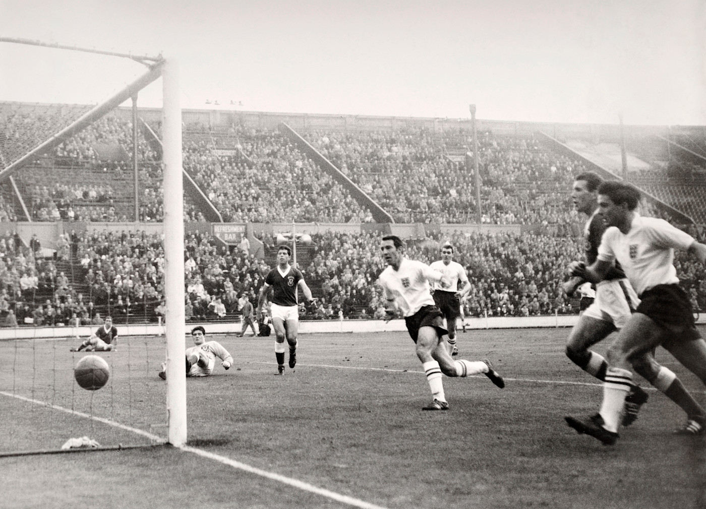 Bobby (on the right of the photo) winning an England cap versus Wales, with Jimmy Greaves inside him