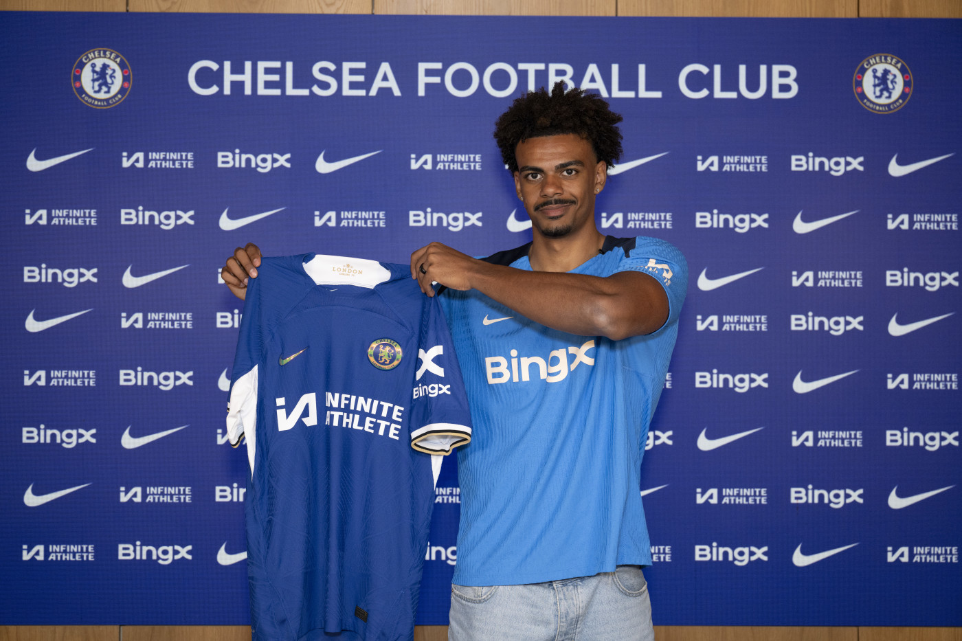 Renato Veiga holding up Chelsea shirt.